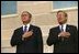 Attending the Pentagon Observance ceremony, President George W. Bush and Secretary of Defense Donald Rumsfeld say the Pledge of Allegiance before speaking Tuesday, Sept. 11, 2002.