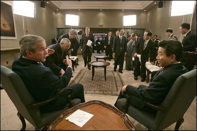 President George W. Bush meets with President Roh Moo-hyun of the Republic of Korea while attending an APEC summit in Santiago, Chile, Nov. 20, 2004. 