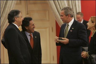 President George W. Bush meets with President Alejandro Toledo of Peru, Manuel Rodriguez Cuadros, Foreign Minister of Peru, far left, and President Toledo's wife, Ms. Elaine Karp, during the APEC Summit at La Moneda Presidential Palace in Santiago, Chile, Sunday, Nov. 21, 2004. 