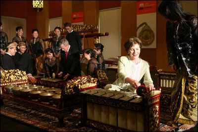 President George W. Bush and Laura Bush create their own music after a traditional gamelan musical performance Thursday, Nov. 16, 2006, at the Asian Civilisations Museum in Singapore. The Bushes are scheduled to depart Singapore on Friday for Vietnam and the 2006 APEC Summit.