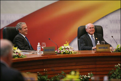 President George W. Bush shares a light moment with Prime Minister John Howard of Australia as they participate in the first retreat of the APEC leaders Saturday, Nov. 18, 2006, at the National Conference Center in Hanoi.