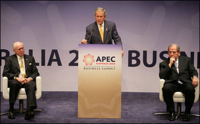 Flanked by Australia's Prime Minister John Howard, left, and Mark Johnson, Chairman of the APEC Business Advisory Council, President George W. Bush delivers remarks Friday, Sept. 7, 2007, to the APEC Business Summit at the Sydney Opera House. President Bush told his audience, "America's commitment to the Asia Pacific region was forged in war and sealed in peace... America is committed to the security of the Asia Pacific region, and that commitment is unshakable."