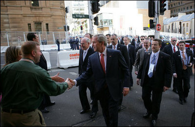 President George W. Bush shakes hands with an unidentified couple Wednesday, Sept. 5, 2007, as he walks to the InterContinental Hotel in Sydney with Prime Minister John Howard of Australia, following their morning meetings.