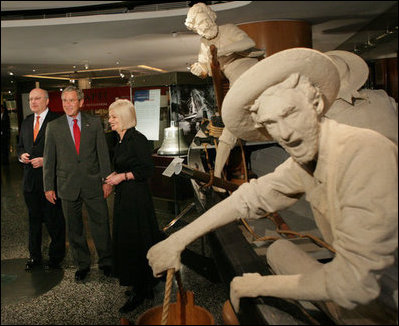 President George W. Bush stands with Senator George Brandis, the Commonwealth Minister for Arts and Sports, and Mary-Louise Williams, museum director, as they stand at the United States of America Gallery at the Australian National Maritime Museum Thursday, Sept. 6, 2007, in Sydney. The exhibit was funded by a $5 million gift for the Bicentennial of European settlement in Australia and was dedicated by President George H.W. Bush in 1992.