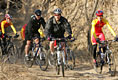 President George W. Bush leads the pack as he joins China's Mountain Biking Team for a ride Sunday afternoon, Nov. 20, 2005, in Beijing.