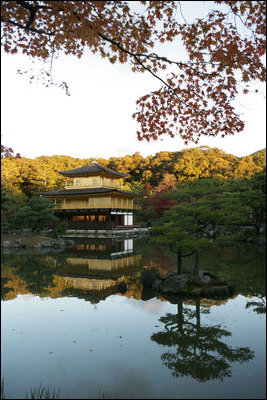 The Golden Pavilion Kinkakuji Temple is reflected in the pool as the sun rises over Kyoto, Japan, Wednesday, Nov. 16, 2005.