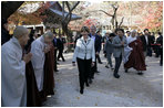President George W. Bush and Laura Bush smile as they are greeted by monks Thursday, Nov. 17, 2005, at the Bulguksa Temple in Gyeongju, Korea.