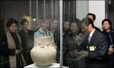 Mrs. Laura Bush looks through exhibition glass at a piece of pottery Thursday, Nov. 17, 2005, during her tour of Gyeongju National Museum in Gyeongju, Korea. With her at right is Mrs. Yang-Sook Kwon, wife of Korea President Moo Hyun Roh.
