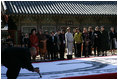 An artist paints calligraphy for the spouses of APEC leaders Friday, Nov. 18, 2005, during their visit to the Beomeosa Temple in Busan, Korea.