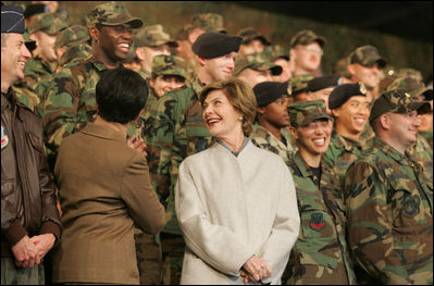 Laura Bush smiles back at the troops Saturday after she and the President stopped en route to China at Osan Air Base in Osan, Korea.