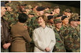 Laura Bush smiles back at the troops Saturday after she and the President stopped en route to China at Osan Air Base in Osan, Korea.