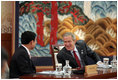 President George W. Bush and Thailand Prime Minister Thaksin Chinnawat share a laugh Friday, Nov. 18, 2005, during an opening session at the two-day, 2005 APEC summit in Busan, Korea.