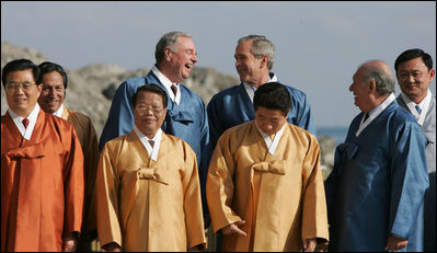 President Bush and Canada's Prime Minister Paul Joseph Martin break out in laughter Saturday, Nov. 19, 2005, as they stand in on the back riser for the official APEC photograph.