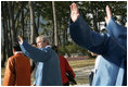 President George W. Bush waves to the crowd after joining his fellow APEC leaders for an official photograph Saturday, Nov. 19, 2005, at the Nurimaru APEC House in Busan, Korea.
