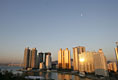 The moon sits over the Gwangan Grand Bridge and the city of Busan, Korea, sight of the 2005 APEC summit.