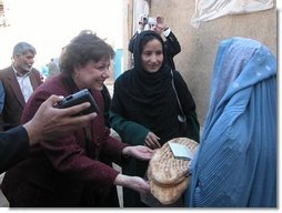 Agriculture Secretary Ann M. Veneman speaks to a woman who receives inexpensive bread from a WFP-funded women's bakery. Veneman announced, in Afghanistan, that the USDA intends to donate $5 million of U.S. agricultural commodities under the Food for Progress Program. Veneman also announced the first Cochran Fellowship Program with Afghanistan to provide short-term, U.S.-based training for eight Afghan women to study agricultural finance.