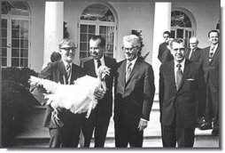 Photograph of President Nixon receiving a Thanksgiving turkey from members during the annual pardoning ceremony.