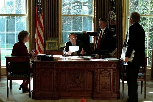 President George W. Bush meet with Karen Hughes, left, Andrew Card, center, and Karl Rove in the Oval Office Dec. 20, 2001. White House photo by Paul Morse.