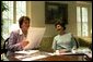 Karen Hughes and Laura Bush discuss publication layouts June 28, 2002. White House photo by Susan Sterner.
