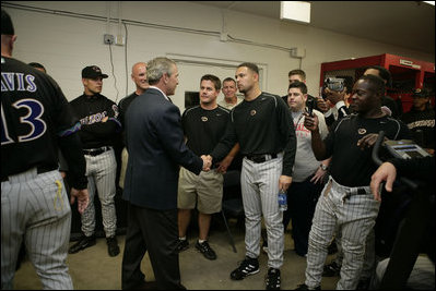 All eyes and cameras are on President George W. Bush as he greets players in the Arizona Diamondback's locker room Thursday, April 15, 2005.  The President was on hand to throw out the first pitch in the inaugural game for the Washington Nationals, who defeated the Diamondbacks,  5-3.