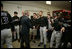All eyes and cameras are on President George W. Bush as he greets players in the Arizona Diamondback's locker room Thursday, April 15, 2005.  The President was on hand to throw out the first pitch in the inaugural game for the Washington Nationals, who defeated the Diamondbacks,  5-3.