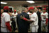 Jose Guillen and President George W. Bush share a laugh as the President joins the Washington Nationals in their locker room prior to opening night at RFK Stadium Thursday, April 14, 2005.