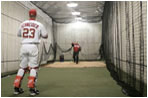 President George W. Bush and Washington Nationals catcher Brian Schneider warm up behind the scenes Thursday night at RFK Stadium.  The President threw out the ceremonial first pitch at the inaugural appearance of the baseball team.