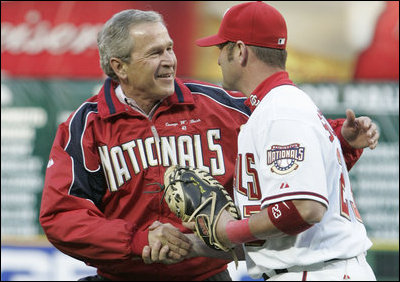 President George W. Bush and Washington Nationals catcher Brian Schneider shake hands after the President threw the ceremonial first pitch Thursday, April 14, 2005.  Schneider went 1 for 3 with an RBI in the Nationals' inaugural home 5-3 win over the Arizona Diamondbacks.
