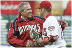 President George W. Bush and Washington Nationals catcher Brian Schneider shake hands after the President threw the ceremonial first pitch Thursday, April 14, 2005.  Schneider went 1 for 3 with an RBI in the Nationals' inaugural home 5-3 win over the Arizona Diamondbacks.
