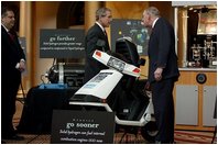 President George W. Bush looks over a scooter powered by solid hydrogen fuel during a demonstration of energy technologies at The National Building Museum in Washington, D.C., Thursday, Feb. 6, 2003. "Cars that will run on hydrogen fuel produce only water, not exhaust fumes," said the President in his remarks. "If we develop hydrogen power to its full potential, we can reduce our demand for oil by over 11 million barrels per day by the year 2040."
