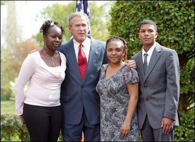 President George W. Bush congratulates the Groundwork Providence Environmental Team of Providence, R.I., on receiving the President’s Environmental Youth Award in the East Garden April 22, 2004. Members of the team include, from left to right, Olabisi Davies, 17, Taja Gonsalves, 15, and Miguel Blanco, 16. 