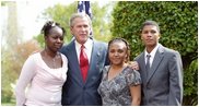 President George W. Bush congratulates the Groundwork Providence Environmental Team of Providence, R.I., on receiving the President’s Environmental Youth Award in the East Garden April 22, 2004. Members of the team include, from left to right, Olabisi Davies, 17, Taja Gonsalves, 15, and Miguel Blanco, 16. 