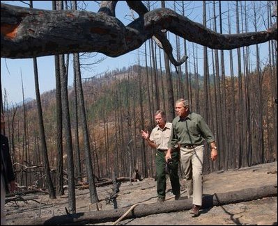President George W. Bush tours the Squires Peak Fire Area in Medford, Ore., with Ron Wenker of the Medford Bureau of Land Management Properties District, Thursday, Aug. 22, 2002. 