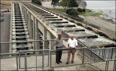 President George W. Bush talks with Witt Anderson during a tour of the Ice Harbor Lock and Dam in Burbank, Wash., Friday,August 22, 2003.
