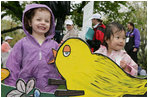 Children pose next to a decorative Easter display on the South Lawn of the White House during the 2006 White House Easter Egg Roll, Monday, April 17, 2006.