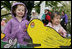 Children pose next to a decorative Easter display on the South Lawn of the White House during the 2006 White House Easter Egg Roll, Monday, April 17, 2006.