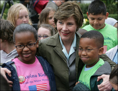 Mrs. Laura Bush embraces two of the Katrina Kids, children from the Katrina ravaged areas of the Gulf Coast, during their visit to the White House to attend the 2006 White House Easter Egg Roll, Monday, April 17, 2006.