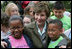 Mrs. Laura Bush embraces two of the Katrina Kids, children from the Katrina ravaged areas of the Gulf Coast, during their visit to the White House to attend the 2006 White House Easter Egg Roll, Monday, April 17, 2006.