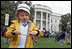 A little boy is careful not to drop his egg as he carries it through the Easter Egg Roll Monday, April 9, 2007, on the South Lawn during the 2007 White House Easter Egg Roll. White House photo by Joyce Boghosian