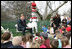 Hall of Fame football player Troy Aikman reads "One Fish, 2 Fish, Red Fish, Blue Fish" for children at the reading nook at the 20008 White House Easter Egg Roll, Monday, March 24, 2008.