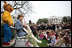 Mrs. Laura Bush, joined by her daughter, Jenna, and the PBS character "Arthur," reads the book "Arthur Meets the President," Monday, March 24, 2008, during festivities at the 2008 White House Easter Egg Roll on the South Lawn of the White House.
