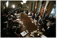 El Presidente Bush es acompañado por miembros de su gabinete mientras se dirige a la prensa el miércoles, 13 de julio de 2005.