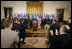 El Presidente George W. Bush acepta el aplauso de legisladores, funcionarios del gobierno e invitados el martes, 2 de agosto en el East Room de la Casa Blanca, en la ceremonia en la que se promulgó la CAFTA Implementation Act.
