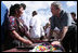 El Presidente George W. Bush conversa con un vendedor en la plaza de Santa Cruz Balanya el lunes, 12 de marzo de 2007, durante un recorrido por la aldea guatemalteca. Foto de Paul Morse de la Casa Blanca.