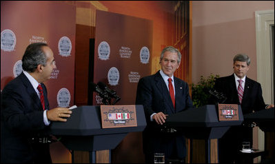 El Presidente George W. Bush y el Primer Ministro de Canadá Stephen Harper escuchan mientras el Presidente Felipe Calderón contesta una pregunta durante su conferencia de prensa conjunta, al concluir la cumbre el pasado 22 de abril de 2008.
