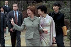 Mrs. Bush waves to members of the media and onlookers as she walks with Kiyoko Fukuda following a lunch and tea ceremony at Akasaka Palace Monday, February 18, 2002 in Tokyo. White House photo by Susan Sterner.