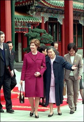 Mrs. Bush and Madame Wang, wife of Chinese President Jiang Zemin, walk from a welcoming tea ceremony at Yuan Dian Hall to lunch in the Xiang Yi Dian Hall in the Zhongnanhai compound Friday, February 22, 2002 in Beijing. White House photo by Eric Draper.