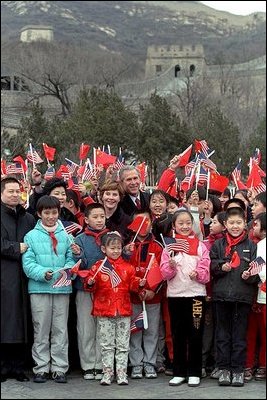 The President and Mrs. Bush pose with a group of Chinese children at the Great Wall of China in Badaling about an hour outside of Beijing, Friday, February 22, 2002. The children waved flags and sang for the Bushes. White House photo by Susan Sterner.