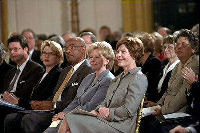 Laura Bush and Lynne Cheney sit with Education Secretary Rod Paige during the White House conference on Preparing Tomorrow.s Teacher, March 5, 2002.