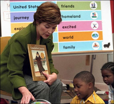 Laura Bush points uses a globe in her reading of the children's book, “Grandfather's Journey”, to students in Mark Williams' kindergarten class at the South 17th Street Elementary School, October 16, 2001.